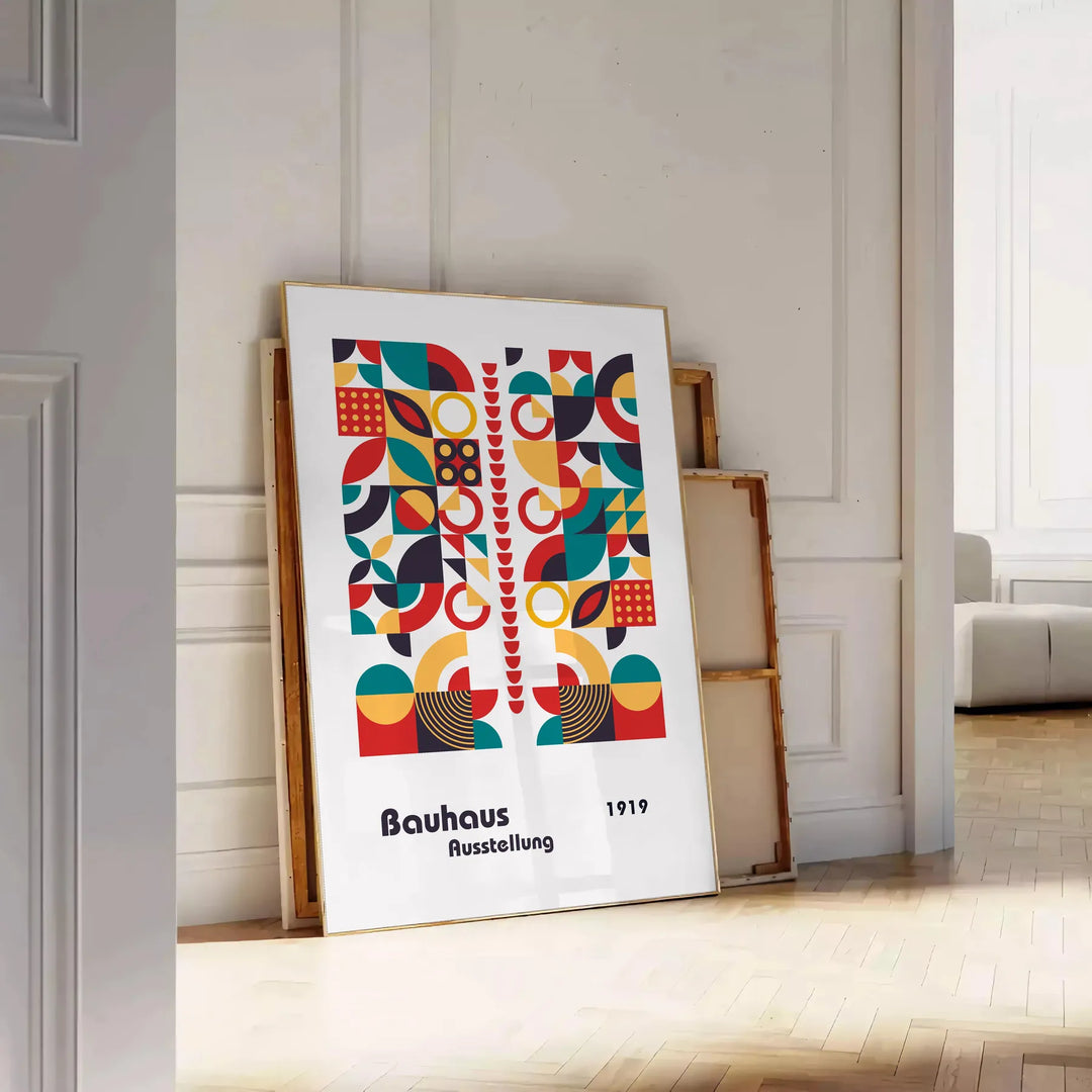 Poster of abstract Bauhaus geometric artwork in white and red - leaning on a herringbone floor against a white panelled wall