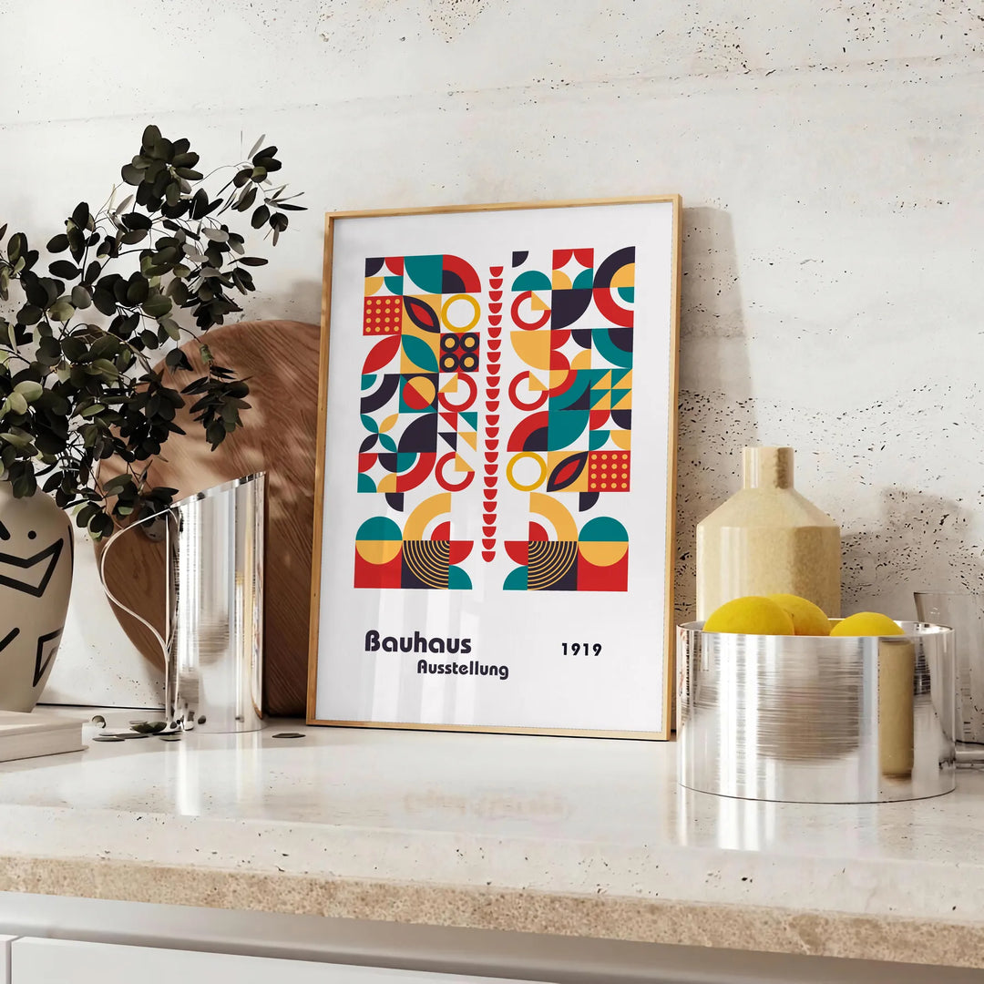 Poster of abstract Bauhaus geometric artwork in white and red - styled on a counter with eucalyptus and a bowl of lemons