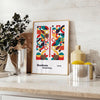 Poster of abstract Bauhaus geometric artwork in white and red - styled on a counter with eucalyptus and a bowl of lemons