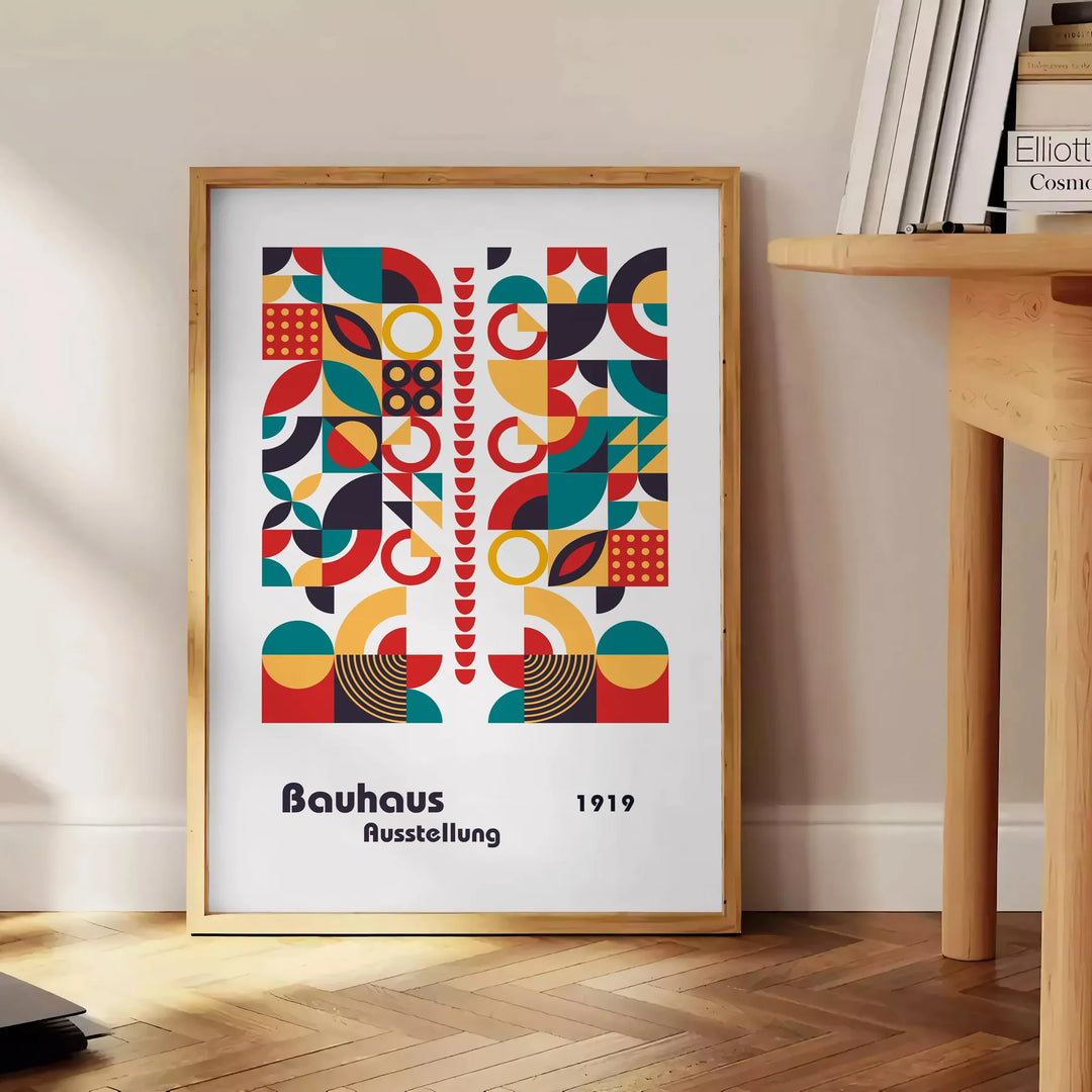 Poster of abstract Bauhaus geometric artwork in white and red - beside a round wooden side table with books