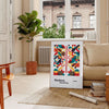 Poster of abstract Bauhaus geometric artwork in white and red - in a Parisian living room with a sofa and a fig plant