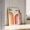 Bauhaus poster showing abstract geometric forms and minimalist composition on paper - leaning on a herringbone floor against a white panelled wall