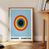 Geometric abstract shapes in gray and brown, inspired by Bauhaus style - beside a round wooden side table with books