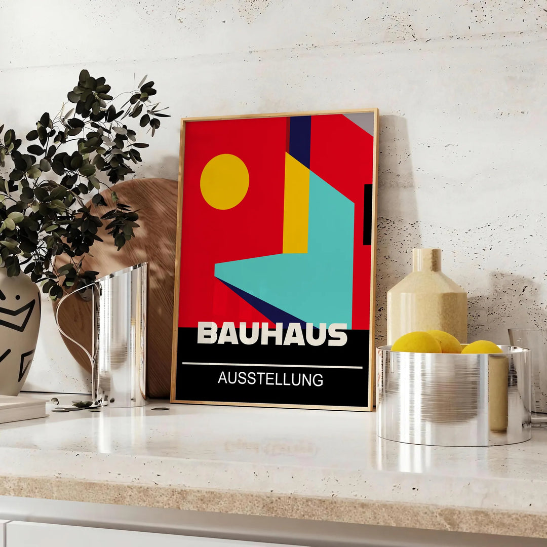 Bauhaus geometric poster in bold red and yellow abstract shapes - styled on a counter with eucalyptus and a bowl of lemons