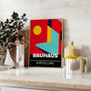 Bauhaus geometric poster in bold red and yellow abstract shapes - styled on a counter with eucalyptus and a bowl of lemons