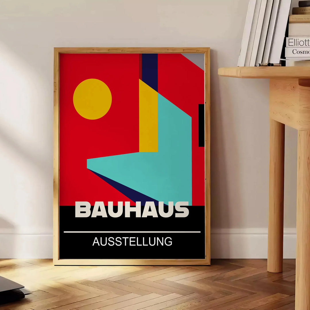Bauhaus geometric poster in bold red and yellow abstract shapes - beside a round wooden side table with books