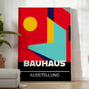 Bauhaus geometric poster in bold red and yellow abstract shapes - in a bright minimalist room with a plant and an armchair