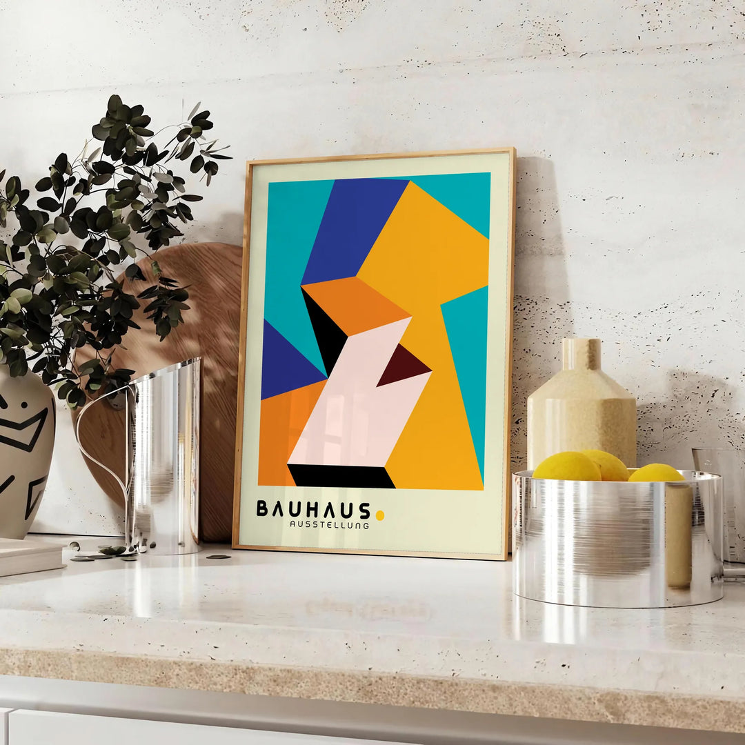 Bauhaus poster with geometric orange and green abstract shapes, modern style - styled on a counter with eucalyptus and a bowl of lemons
