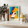 Bauhaus poster with geometric orange and green abstract shapes, modern style - styled on a counter with eucalyptus and a bowl of lemons