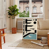 Bauhaus-style swimming pool with geometric shapes and bold colors - in a Parisian living room with a sofa and a fig plant