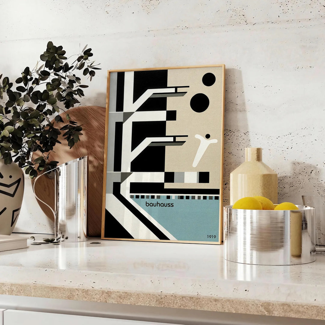 Bauhaus style illustration of a swimming pool with geometric shapes and muted colors - styled on a counter with eucalyptus and a bowl of lemons