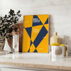 Poster showing abstract geometric composition in Bauhaus style, minimal modern design - styled on a counter with eucalyptus and a bowl of lemons