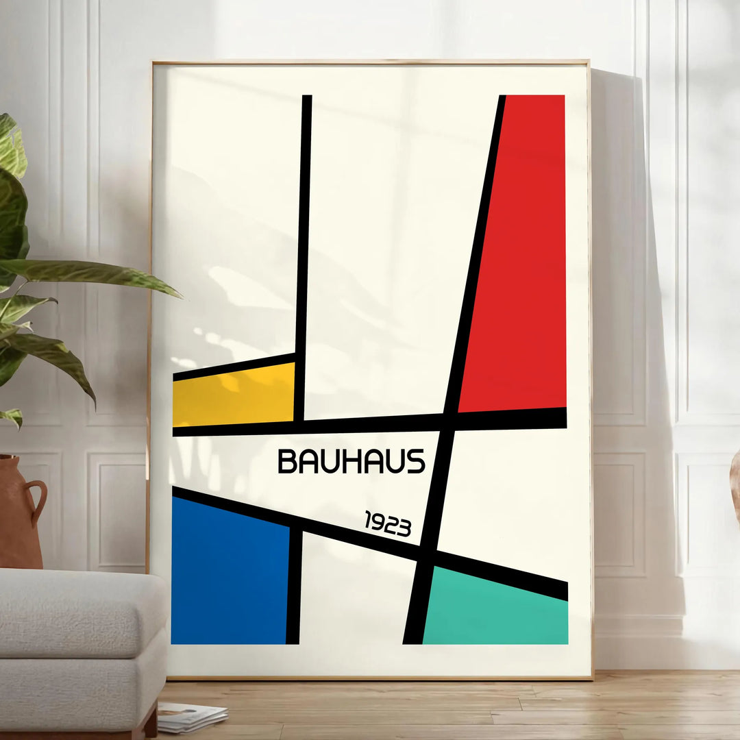 Bauhaus geometric poster with abstract shapes in red, blue, and yellow - in a bright minimalist room with a plant and an armchair