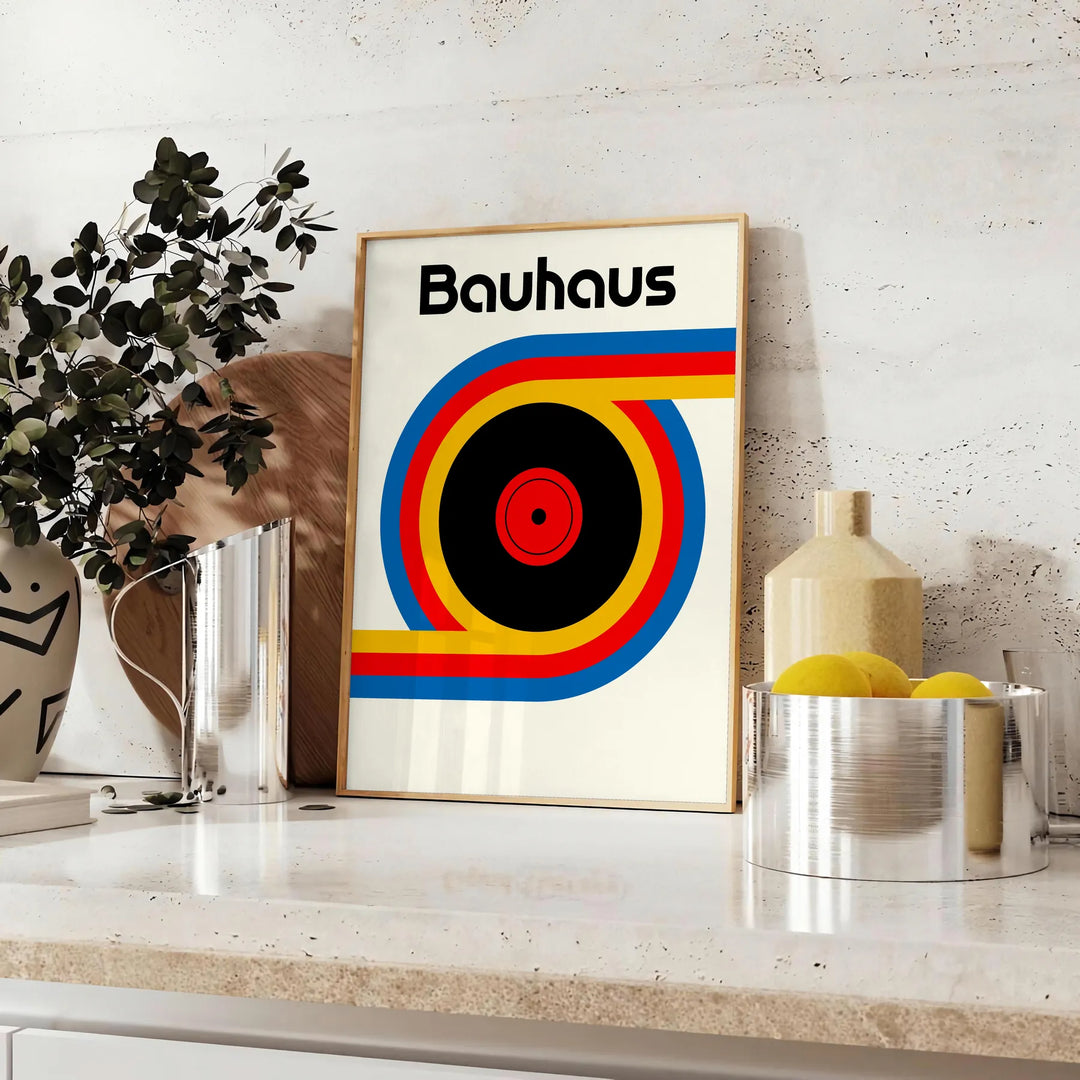 Poster showing Bauhaus geometric artwork with bold shapes and modern composition - styled on a counter with eucalyptus and a bowl of lemons