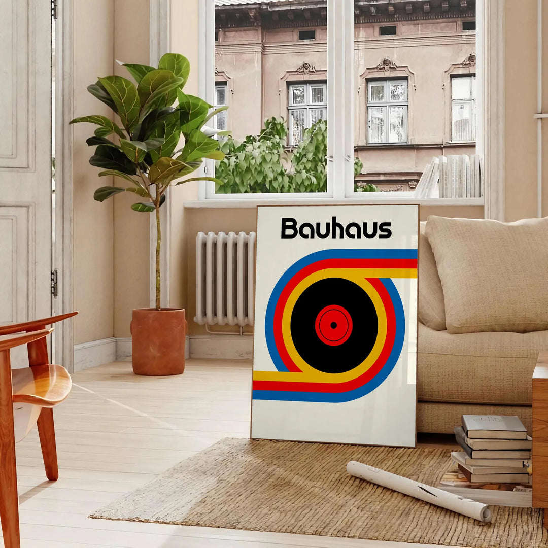 Poster showing Bauhaus geometric artwork with bold shapes and modern composition - in a Parisian living room with a sofa and a fig plant
