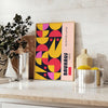 Poster showing abstract Bauhaus geometric artwork in yellow and black - styled on a counter with eucalyptus and a bowl of lemons