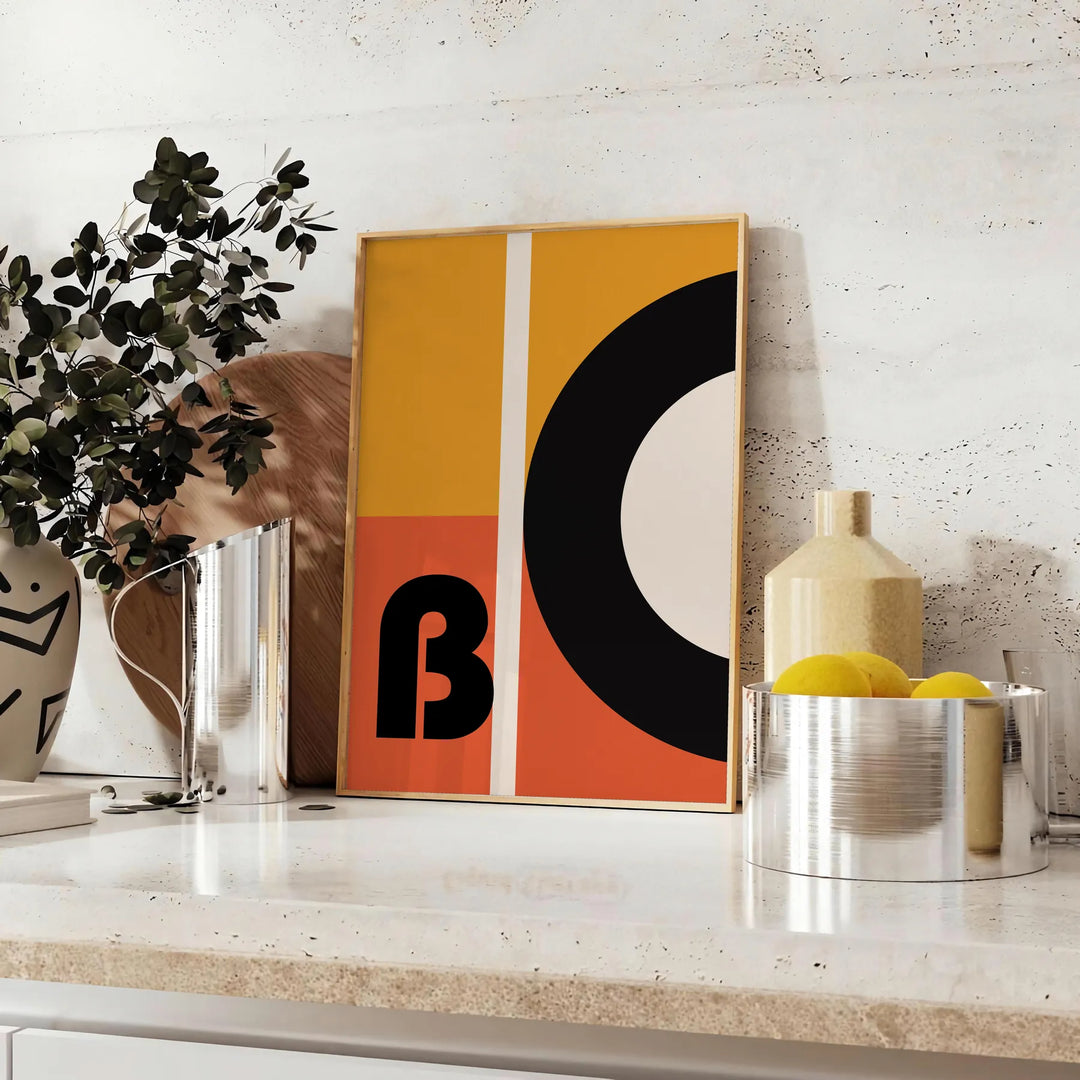 Brown and black geometric Bauhaus poster with minimalist abstract shapes - styled on a counter with eucalyptus and a bowl of lemons