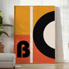 Brown and black geometric Bauhaus poster with minimalist abstract shapes - in a bright minimalist room with a plant and an armchair