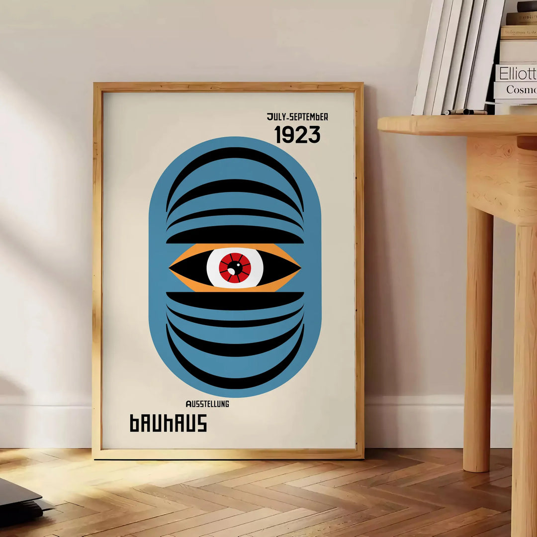 Bauhaus style geometric poster showing abstract shapes in minimalist composition - beside a round wooden side table with books