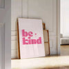 Colorful abstract design featuring the phrase 'Be Kind' in playful typography - leaning on a herringbone floor against a white panelled wall