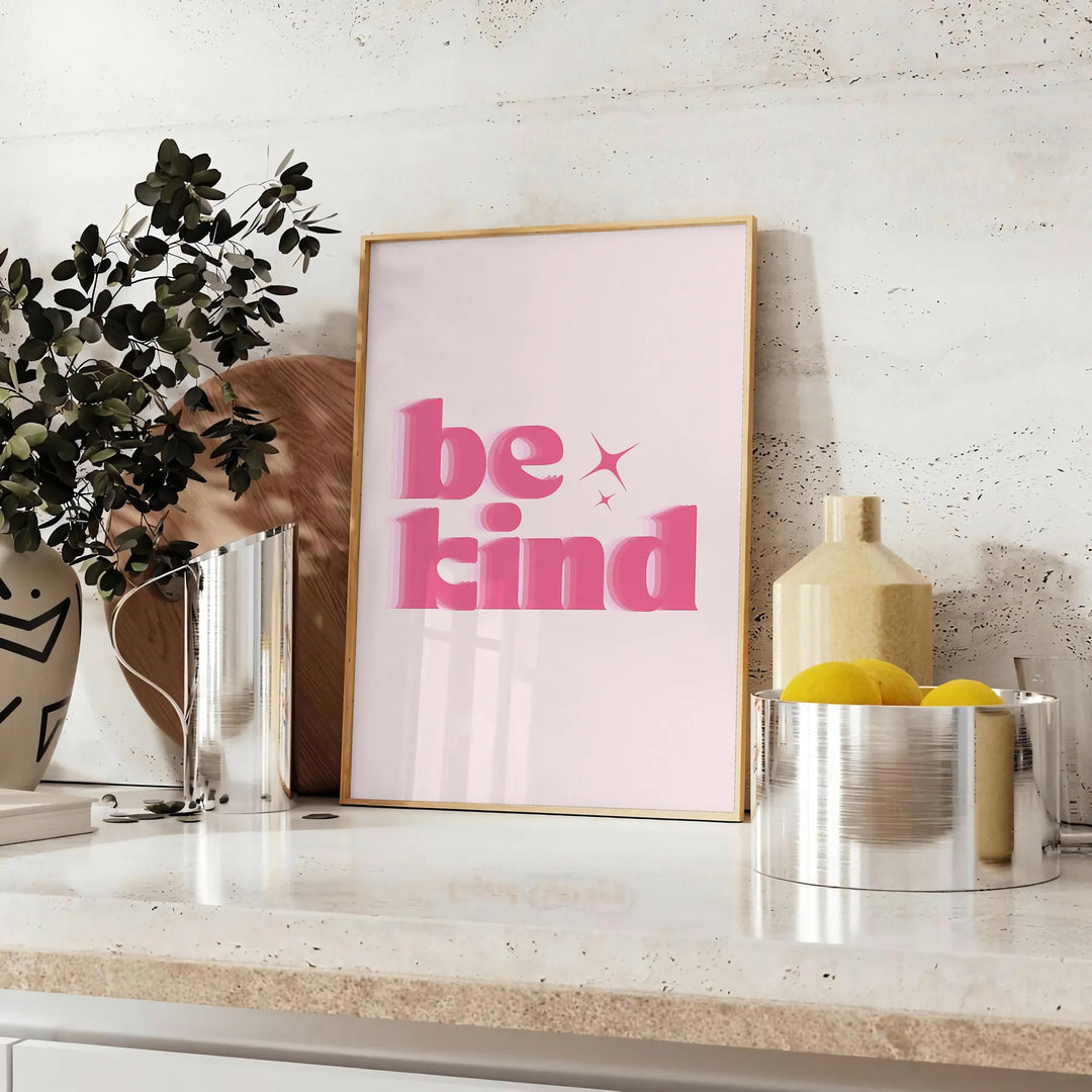 Colorful abstract design featuring the phrase 'Be Kind' in playful typography - styled on a counter with eucalyptus and a bowl of lemons