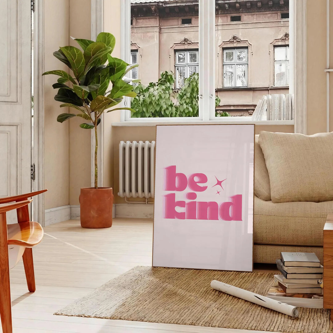 Colorful abstract design featuring the phrase 'Be Kind' in playful typography - in a Parisian living room with a sofa and a fig plant