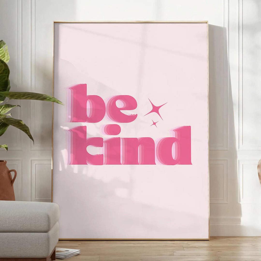 Colorful abstract design featuring the phrase 'Be Kind' in playful typography - in a bright minimalist room with a plant and an armchair