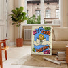 A retro-style poster featuring a sun with groovy typography in orange and gray - in a Parisian living room with a sofa and a fig plant