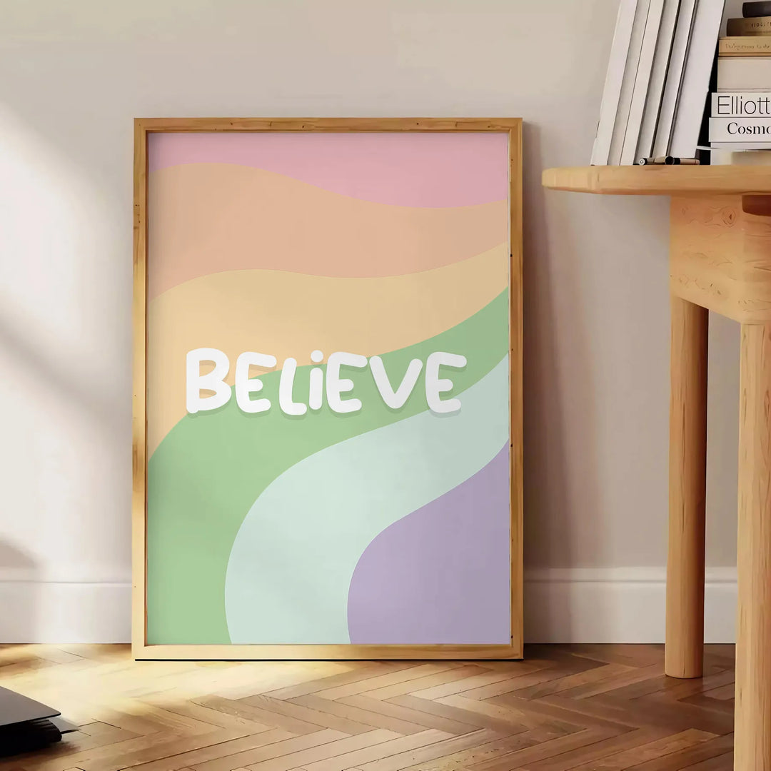 Abstract design with the word 'Believe' in green and orange hues - beside a round wooden side table with books