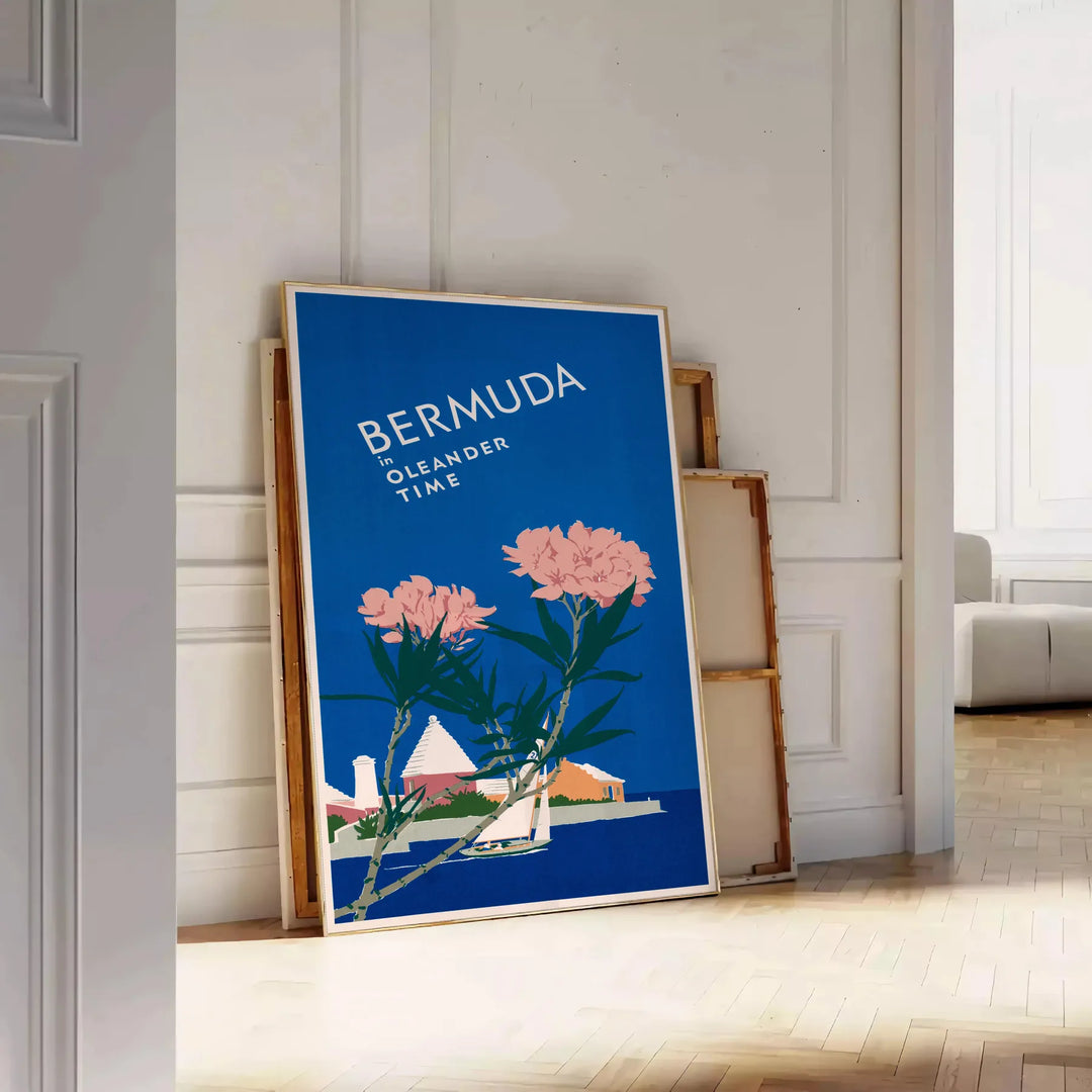 Bermuda travel poster featuring a serene beach scene with blue and green hues - leaning on a herringbone floor against a white panelled wall