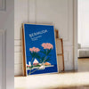Bermuda travel poster featuring a serene beach scene with blue and green hues - leaning on a herringbone floor against a white panelled wall