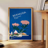 Bermuda travel poster featuring a serene beach scene with blue and green hues - beside a round wooden side table with books