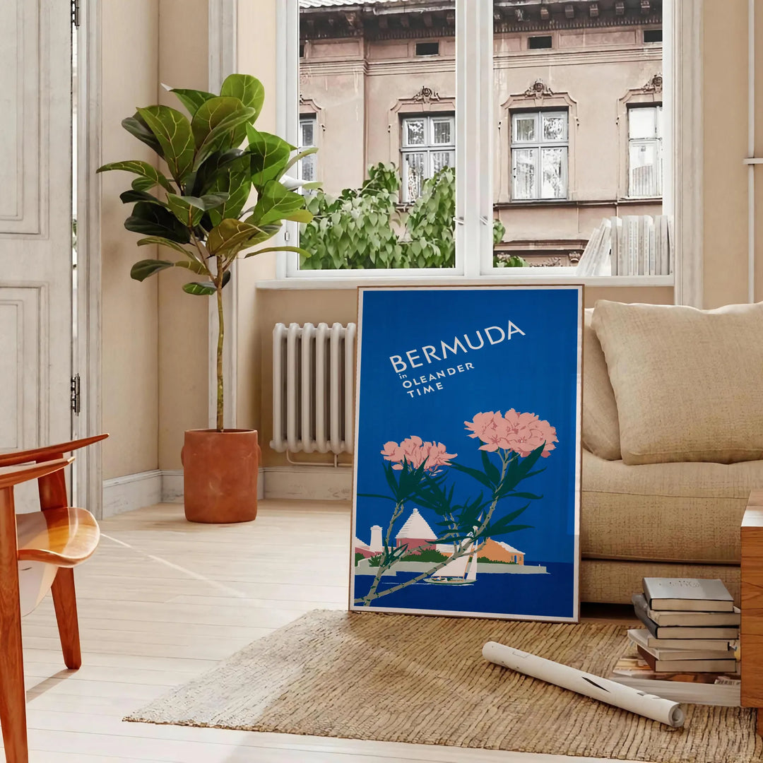 Bermuda travel poster featuring a serene beach scene with blue and green hues - in a Parisian living room with a sofa and a fig plant