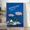 Bermuda travel poster featuring a serene beach scene with blue and green hues - in a bright minimalist room with a plant and an armchair