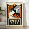 Orange and black Biarritz surf poster in minimalist retro graphic style - in a bright minimalist room with a plant and an armchair