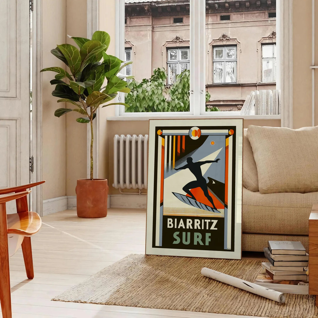 Orange and black Biarritz surf poster in retro graphic style - in a Parisian living room with a sofa and a fig plant