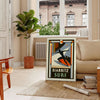 Orange and black Biarritz surf poster in retro graphic style - in a Parisian living room with a sofa and a fig plant