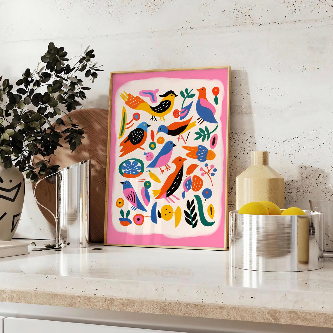 A colorful bird illustration with bold orange and blue hues - styled on a counter with eucalyptus and a bowl of lemons
