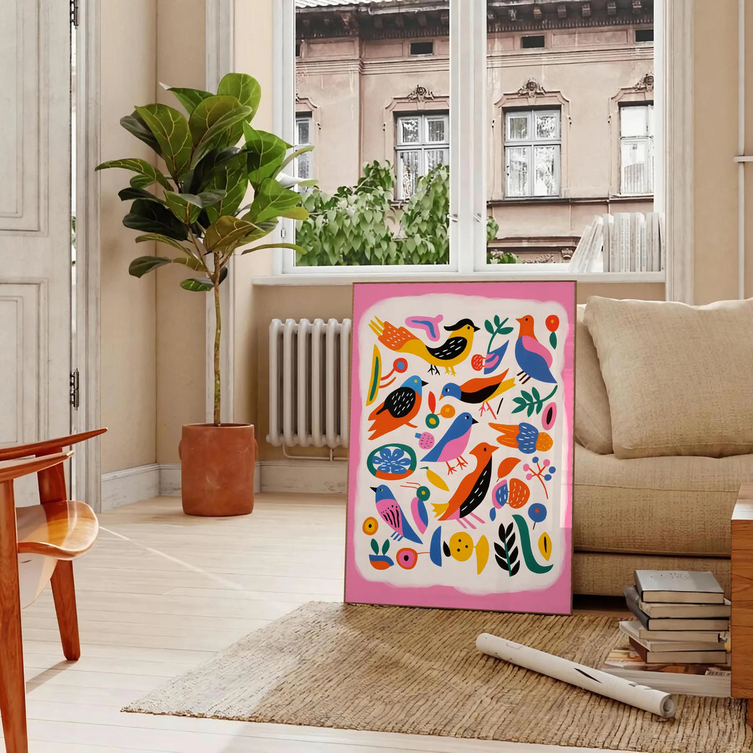 A colorful bird illustration with bold orange and blue hues - in a Parisian living room with a sofa and a fig plant