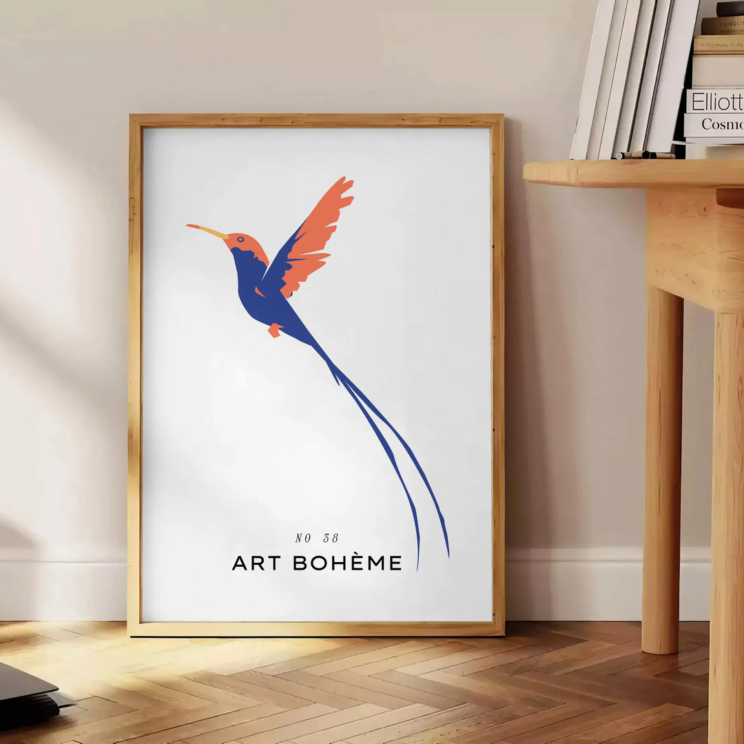 Colorful bird illustration with orange and blue hues on a dark background - beside a round wooden side table with books