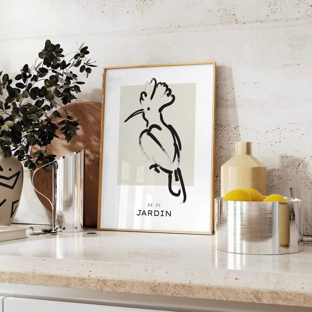 A bohemian-style poster featuring a bird in shades of gray and black - styled on a counter with eucalyptus and a bowl of lemons