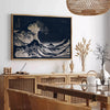 Black and white depiction of Hokusai's wave with green accents - in a Parisian living room with a sofa and a fig plant