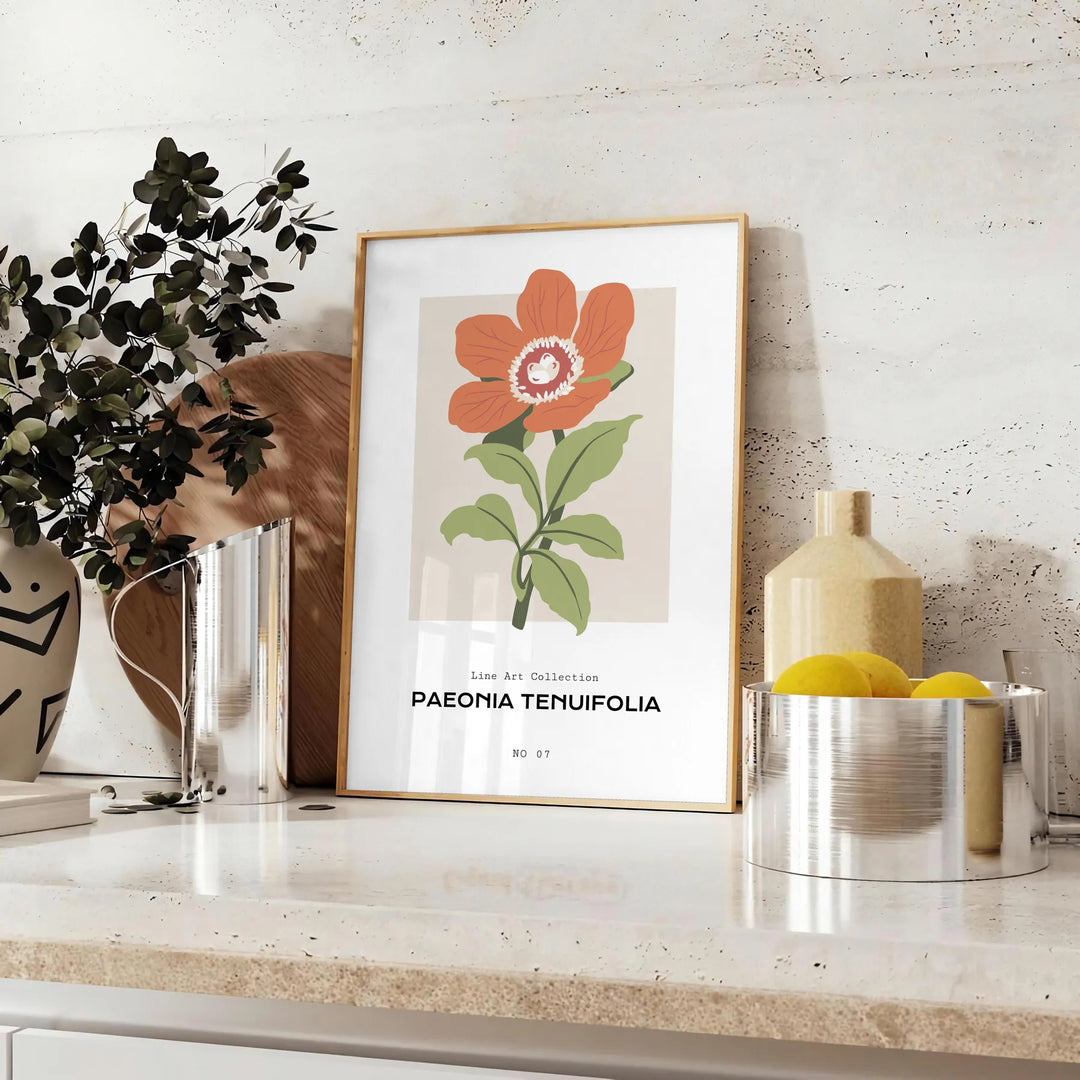 A close-up of colorful blossoms in shades of green and orange - styled on a counter with eucalyptus and a bowl of lemons