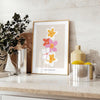 abstract flower design with black and orange hues - styled on a counter with eucalyptus and a bowl of lemons