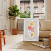 abstract flower design with black and orange hues - in a Parisian living room with a sofa and a fig plant