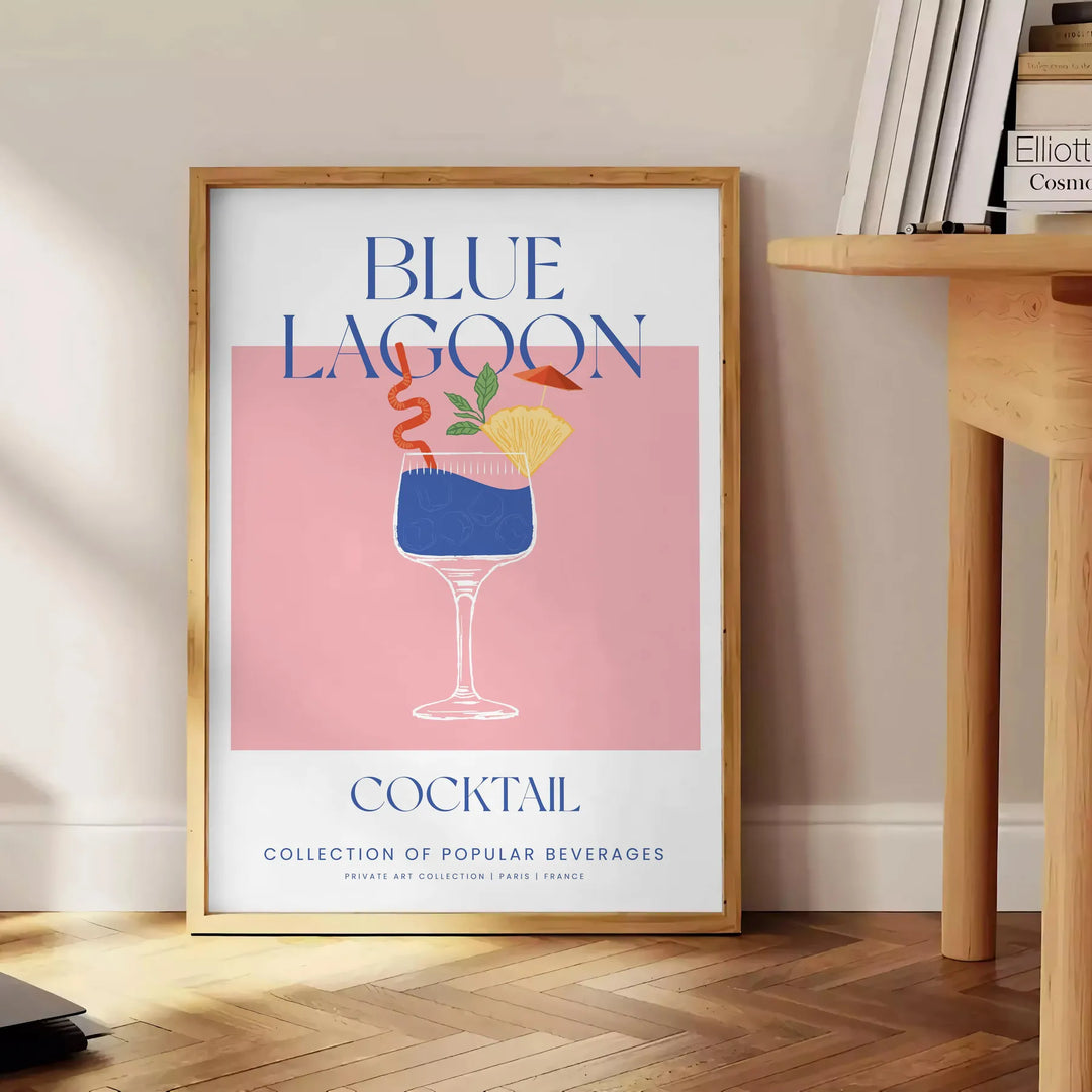 A colorful illustration of a Blue Lagoon cocktail with tropical elements - beside a round wooden side table with books