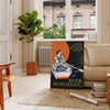 A serene boat sailing on calm waters, with gray and black tones. - in a Parisian living room with a sofa and a fig plant