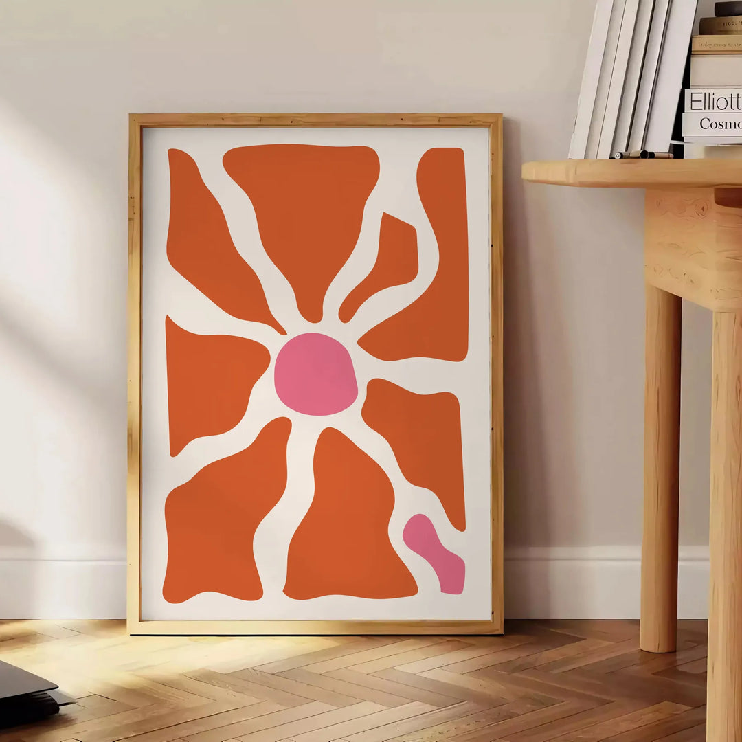 Abstract shapes in warm browns and oranges with a bohemian style - beside a round wooden side table with books