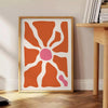 Abstract shapes in warm browns and oranges with a bohemian style - beside a round wooden side table with books