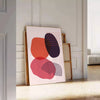 Colorful abstract shapes and patterns in a boho style - leaning on a herringbone floor against a white panelled wall